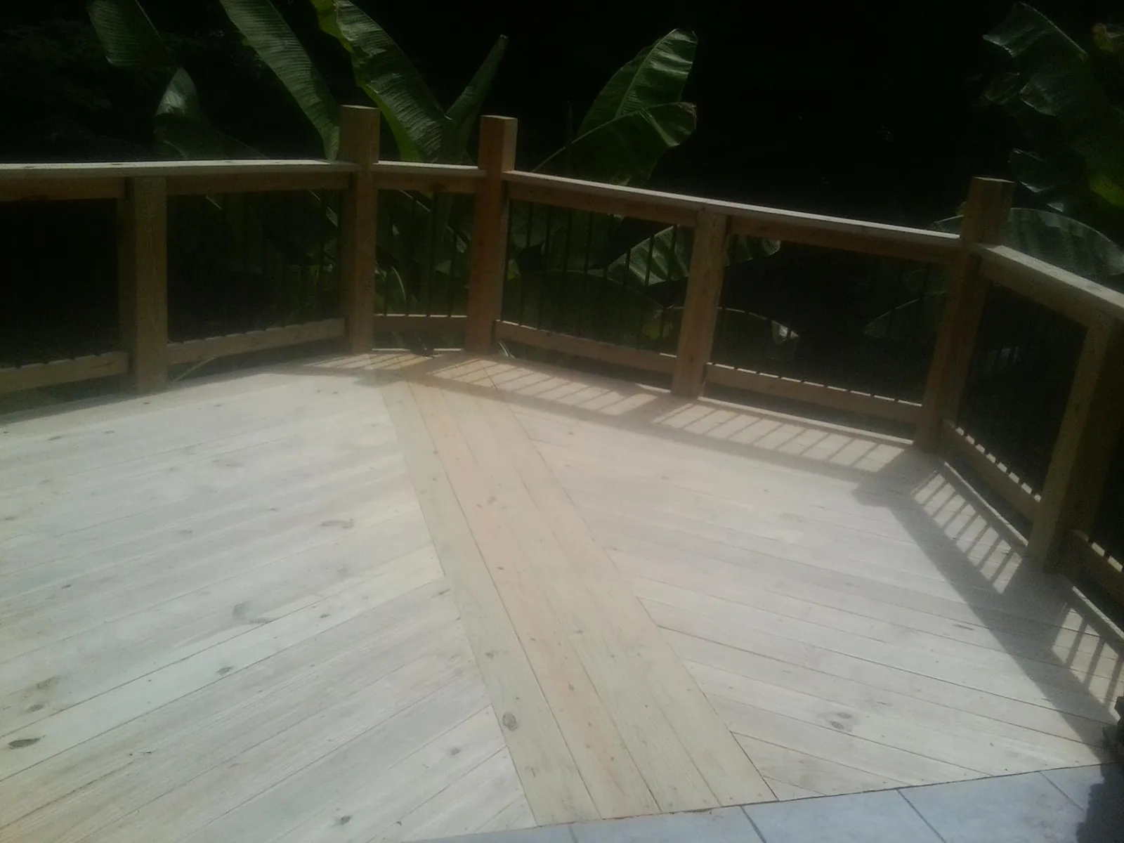 New wood deck and railing built off the back of a home in Kenvil