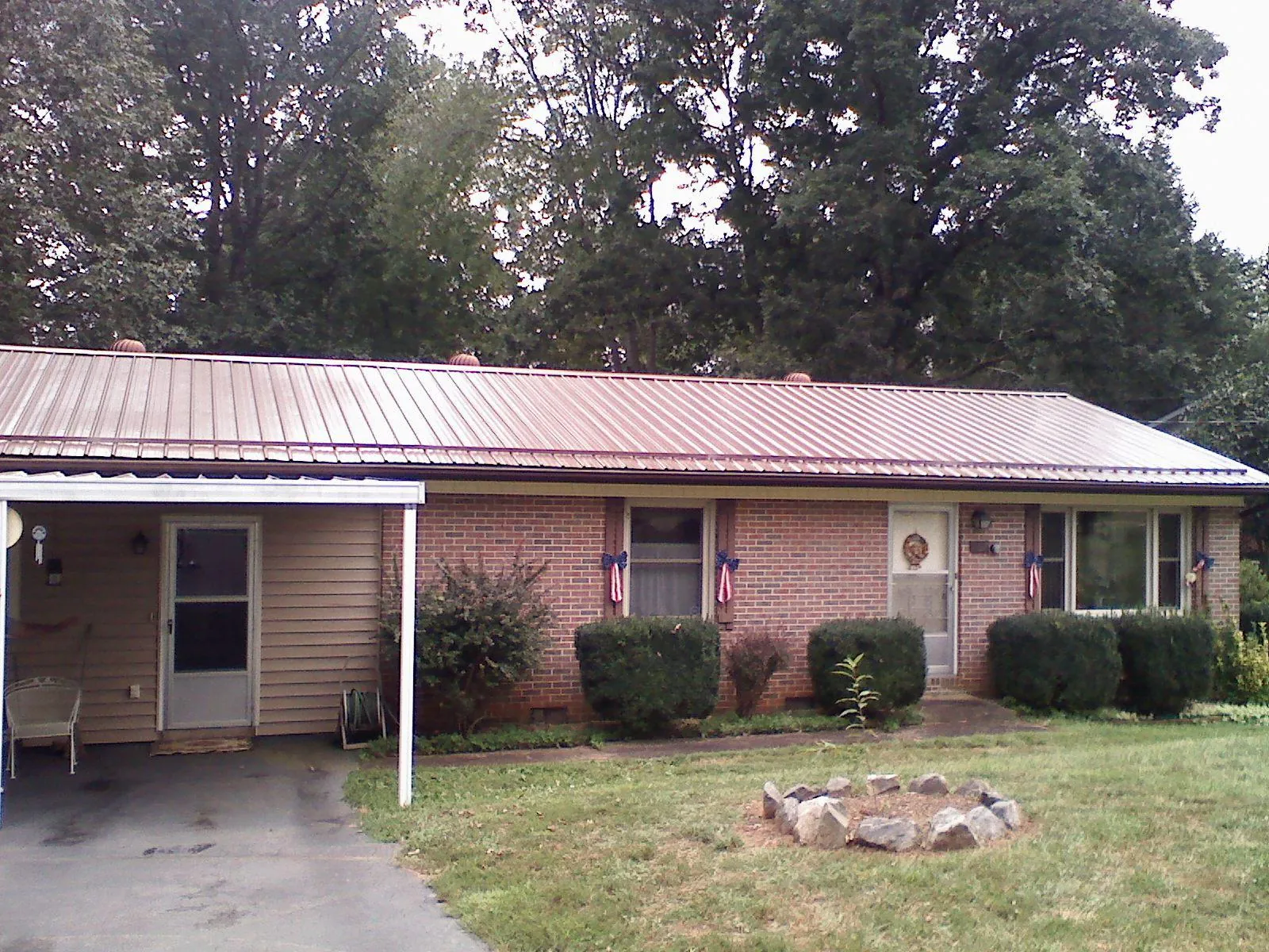 Bronze metal roof and carport on a brick ranch home — Roof Repair work by our crew in Kenvil